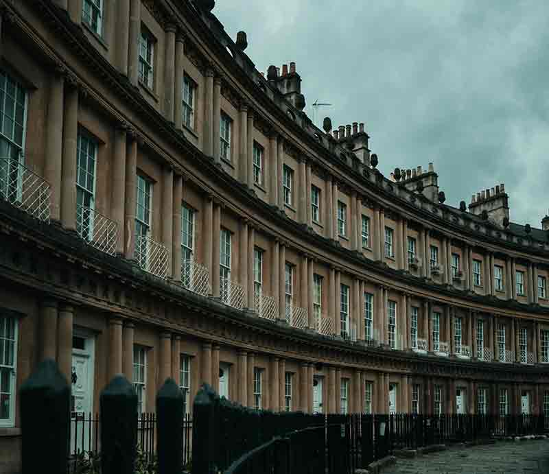 Yellow Bath stone curved façade with columns.