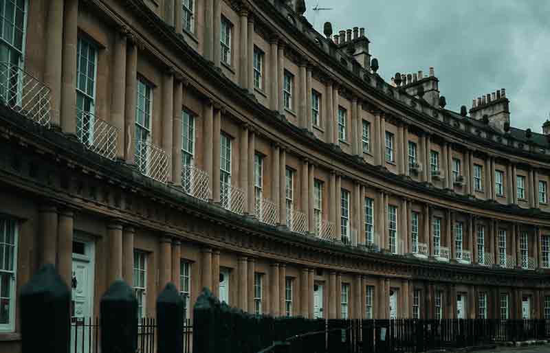 Yellow Bath stone curved façade with columns.